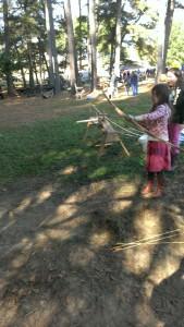 Sophia shooting a bow and arrow